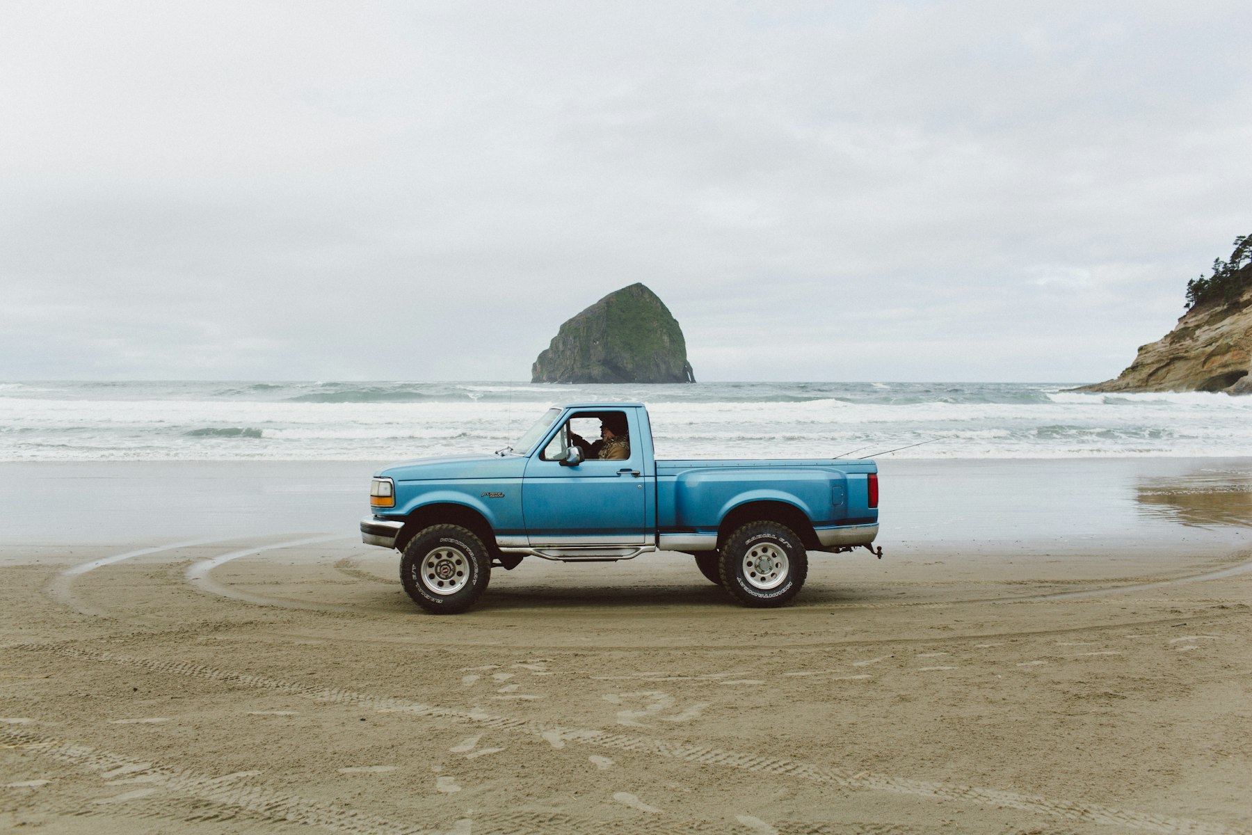 A pickup truck parked on the beach